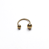 Gold open-band ring with polished sphere ends, minimalist adjustable statement ring on a white background.