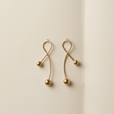 Curved middle components of the ELAI modular gold earrings shown separately