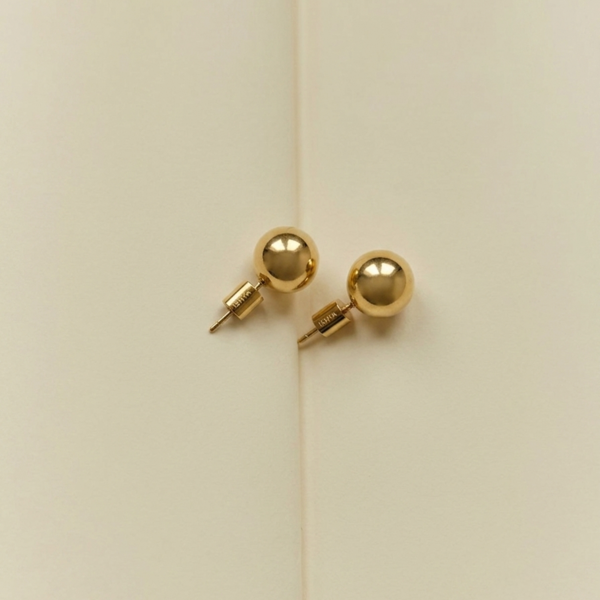 ELAI gold sphere stud components shown separately